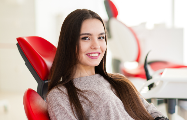 Young woman sitting in dental chair