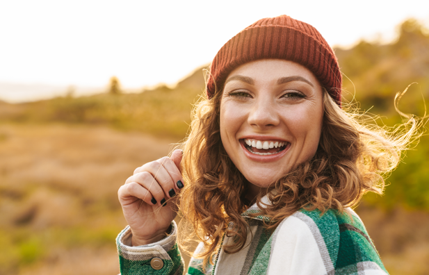 Young woman smiling while hiking.